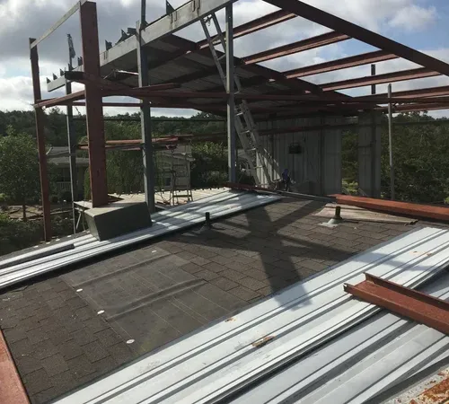 Metal building construction steel frame going up